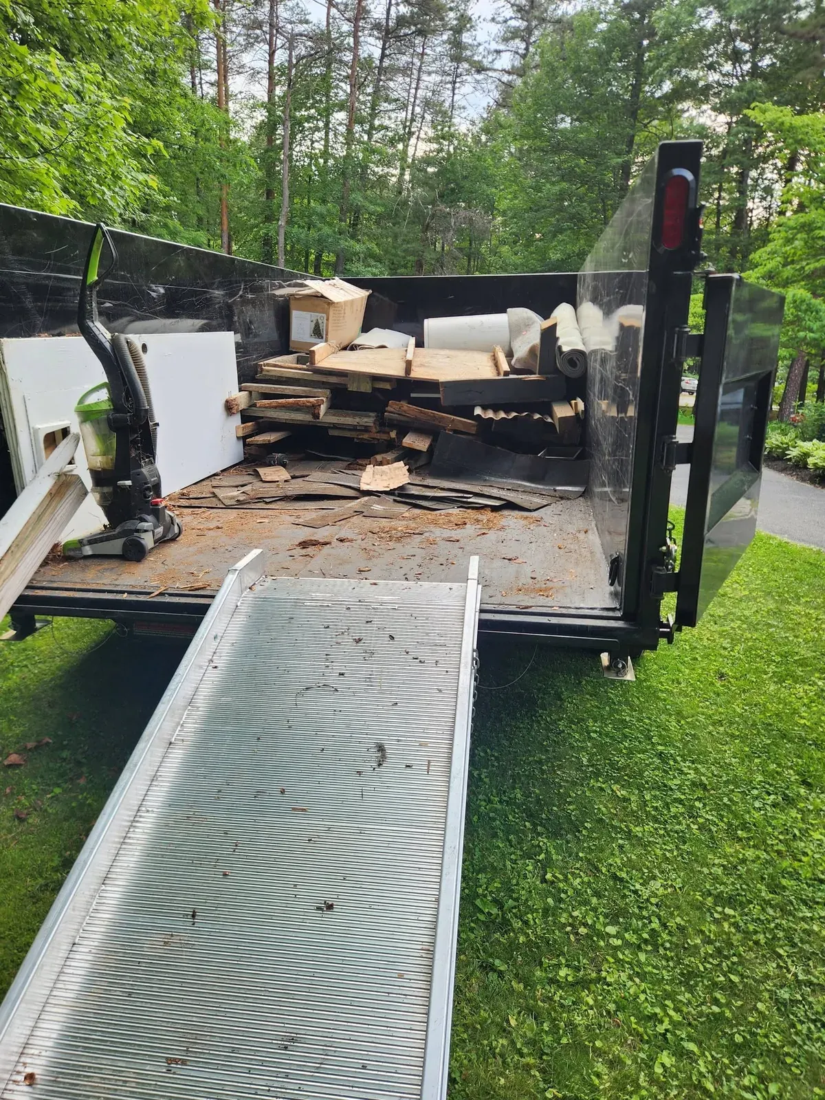 Dump trailer loaded with scrap wood and construction debris