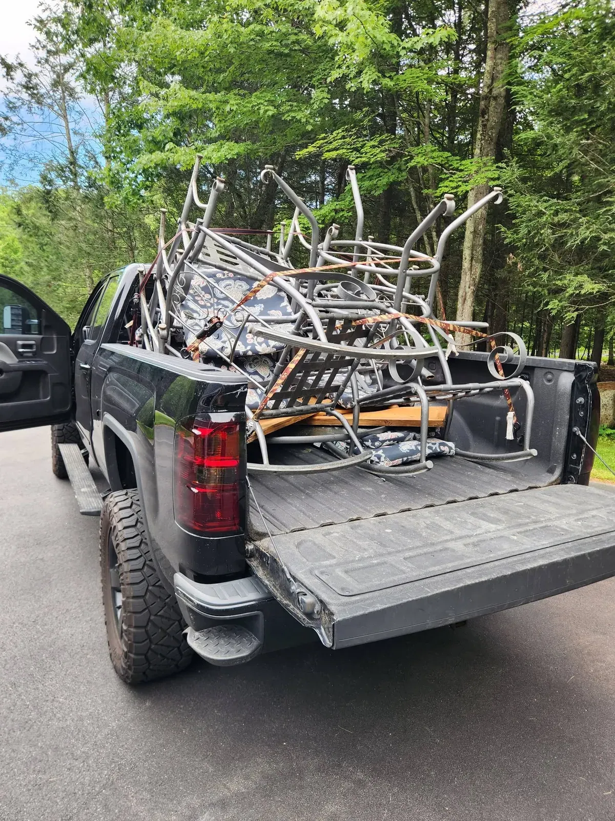 Metal patio furniture piled high in the pickup bed