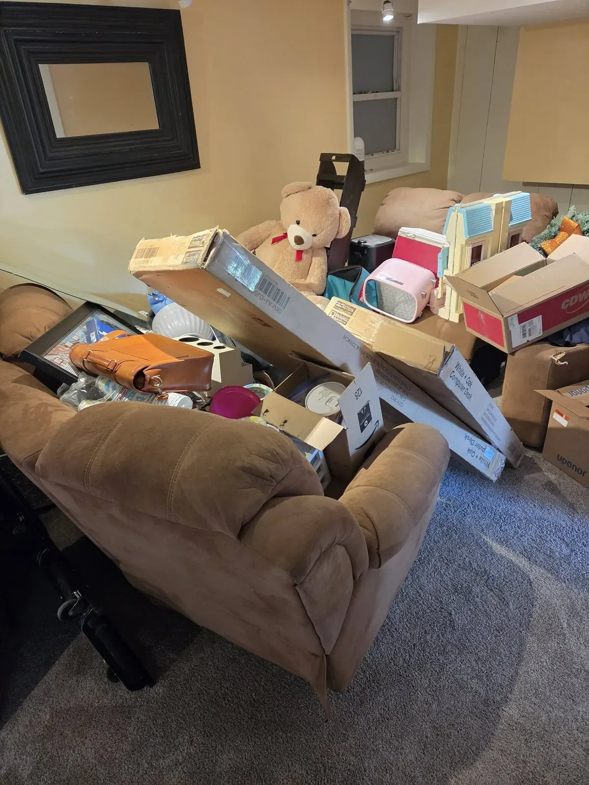 Brown recliner buried under boxes and household items