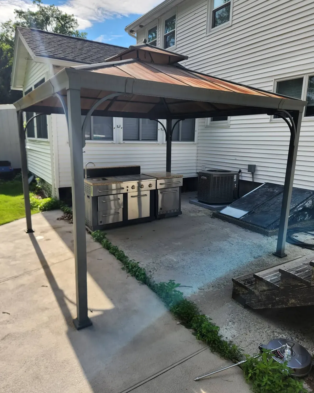 Metal gazebo over a patio before removal
