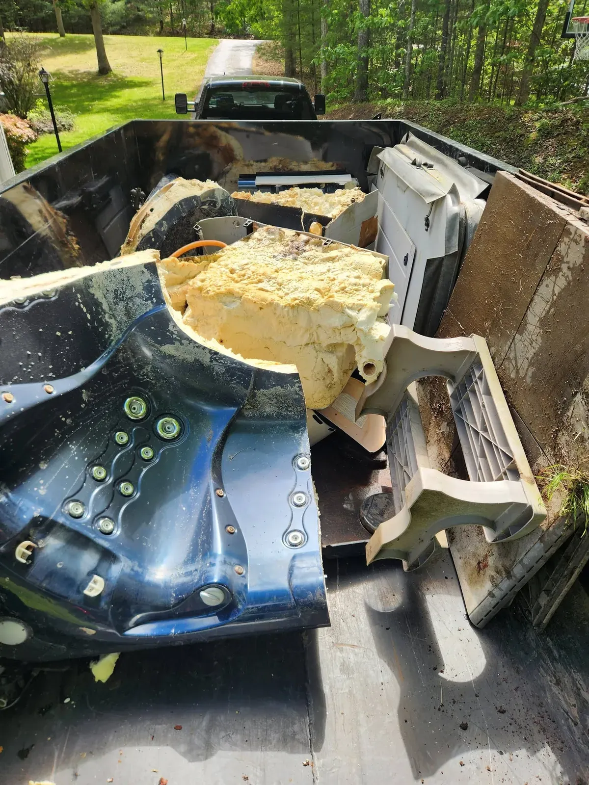 Pieces of a demolished hot tub loaded in the truck bed