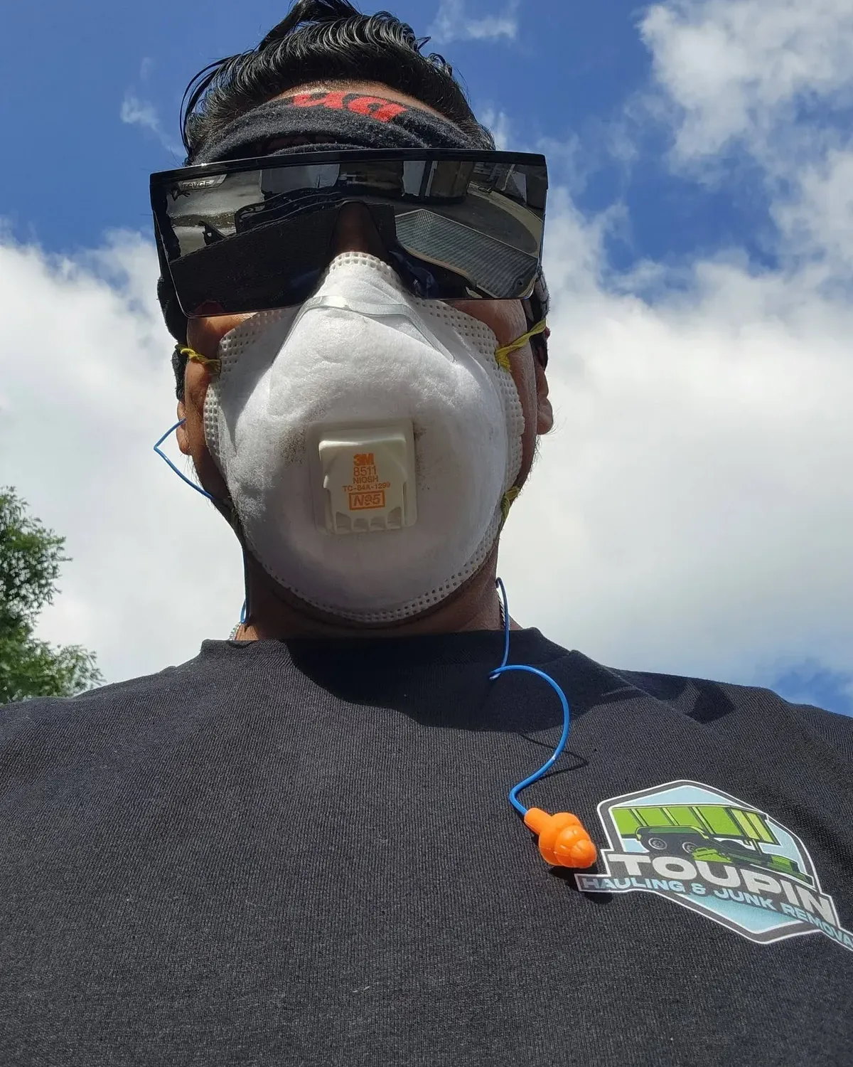 James Toupin wearing a respirator and safety glasses on a job