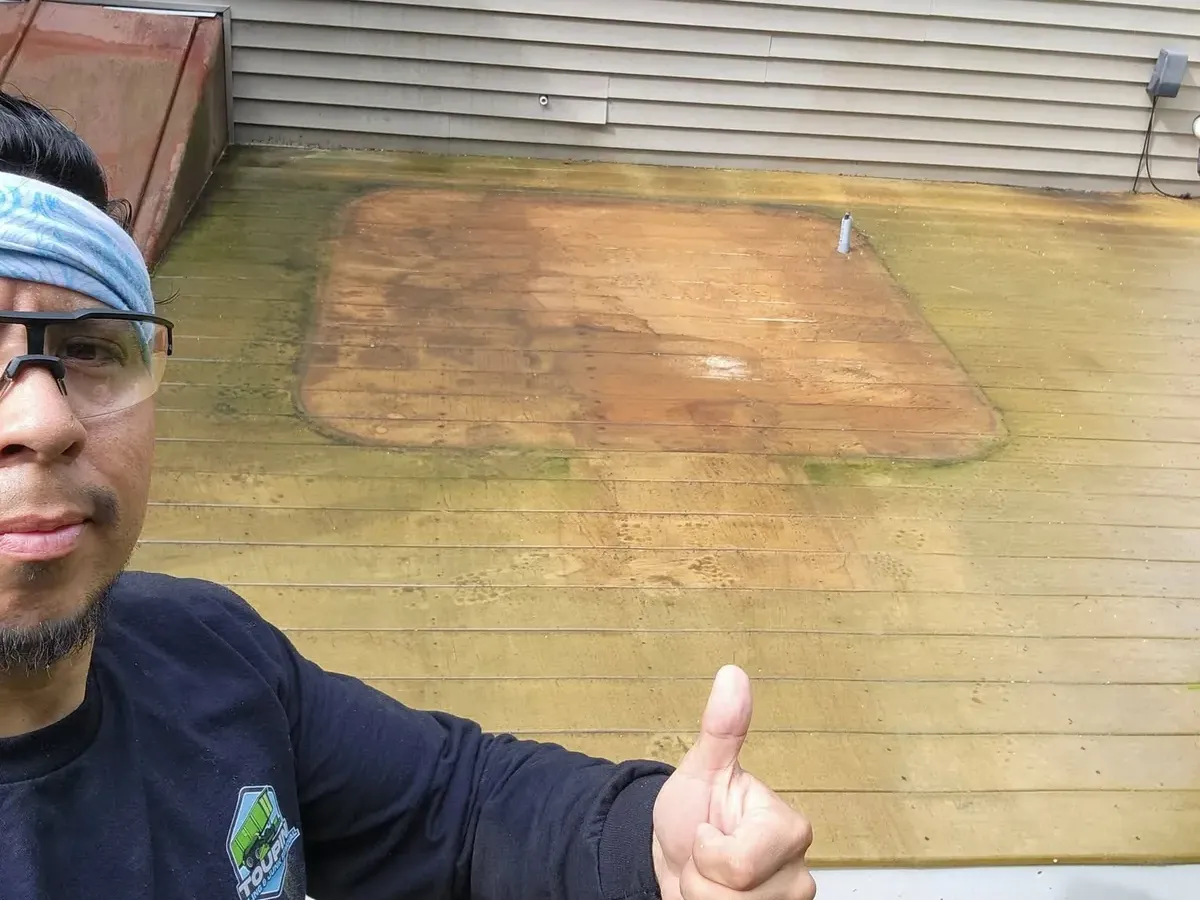 James Toupin giving a thumbs up on a deck after a hot tub was removed