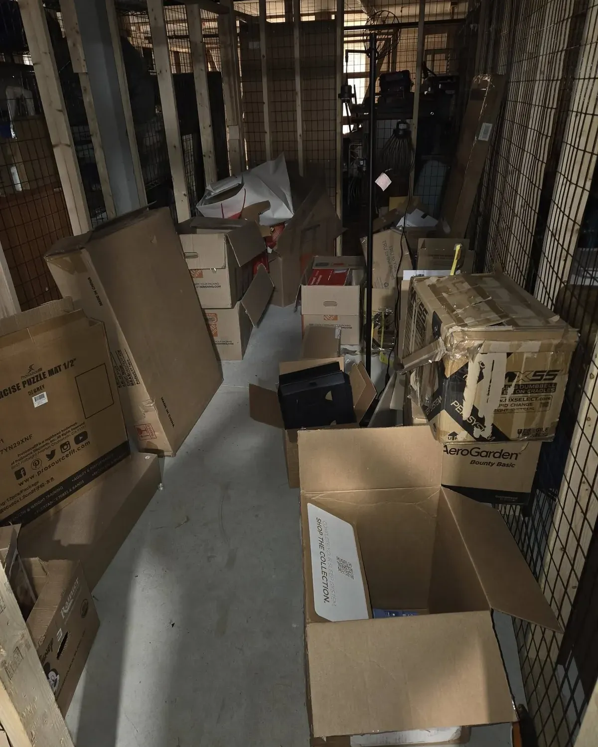 Storage unit aisle stacked with boxes