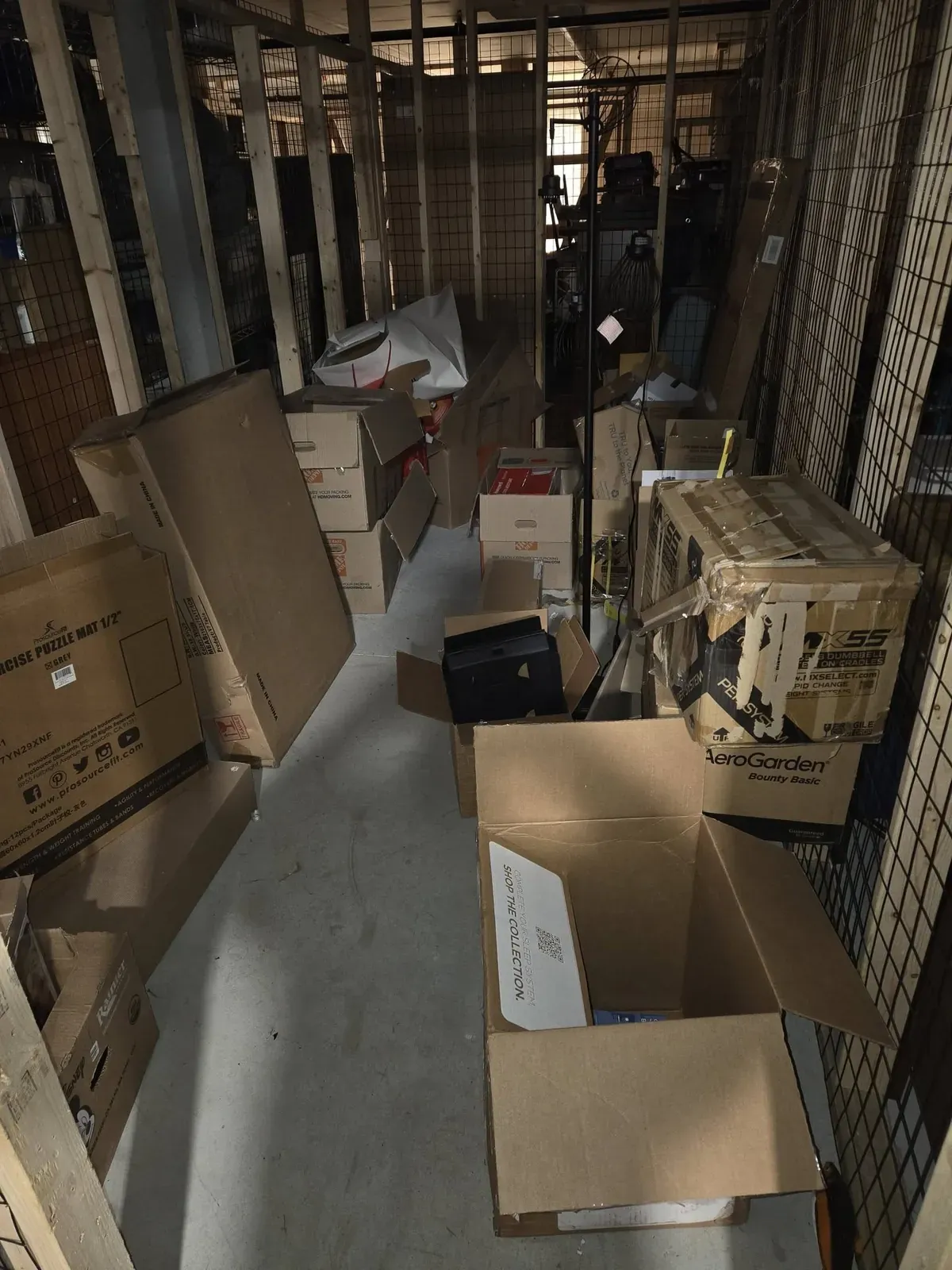 Storage unit aisle stacked with boxes