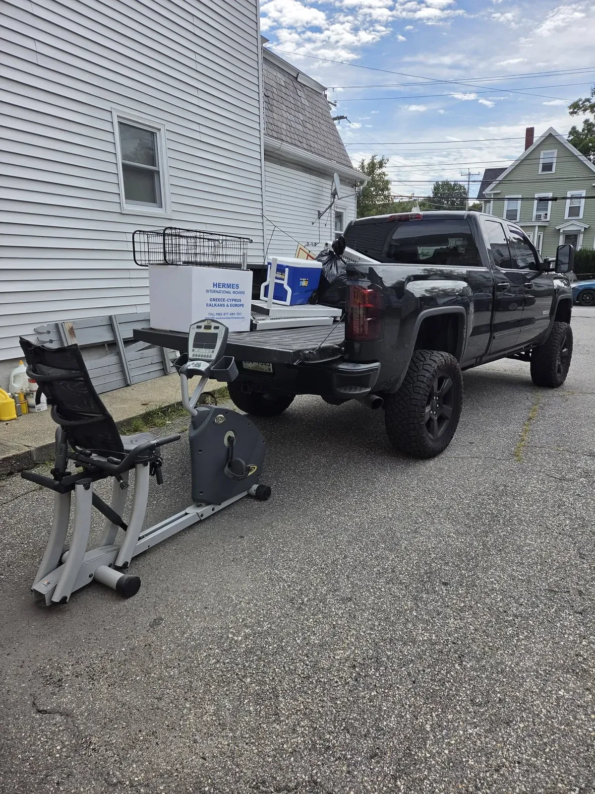Recumbent exercise bike and boxes beside the pickup, ready to load
